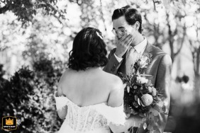 Tears well in the groom’s eyes in Philadelphia, Pennsylvania as he catches his first glimpse of the bride, his face reflecting the emotional significance of the day.
